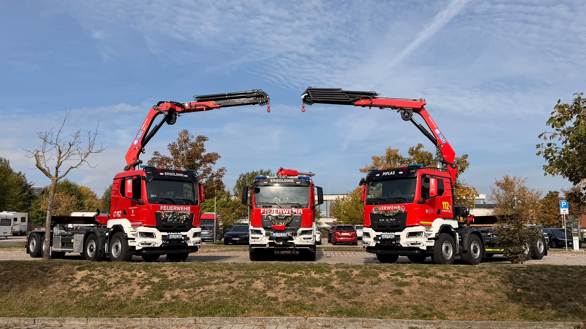 Die Feuerwehren Ergolding und Piflas haben neue Einsatzfahrzeuge erhalten: ein Tanklöschfahrzeug (TLF, Mitte) für die FF Ergolding sowie jeweils ein Wechselladerfahrzeug (WLF) für die FF Ergolding und die FF Piflas.